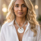 Model wearing the Glitter Ball Multi Chain recycled silver statement necklace in an urban setting, full face view showing large textured disc pendant and multi-strand chain at neckline