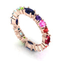 Handmade 18ct rose gold eternity ring from the Allsorts collection, featuring a vibrant spectrum of multi-coloured gemstones including sapphire, ruby, and aquamarine.