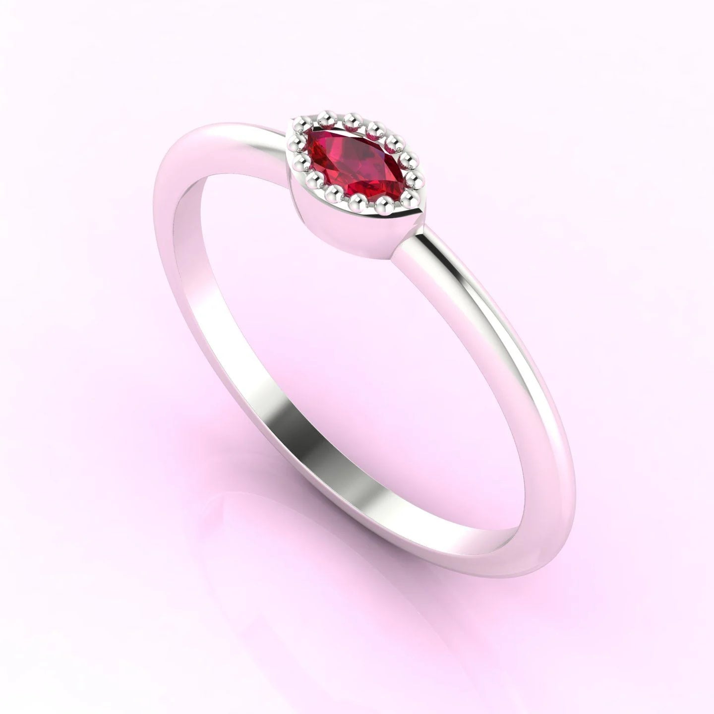 Three-quarter view of a handmade marquise ruby ring showing the beaded setting in platinum.