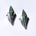 Front view of the Art Deco sterling silver earrings featuring green tsavorite garnets and a black geometric design.