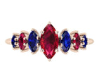 Front view of the Harlequin seven-stone ring in 18ct rose gold, with a central marquise ruby and alternating blue sapphires and red rubies.