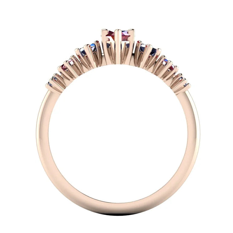 Profile view of the Harlequin ruby and blue sapphire ring, showing its raised open claw settings and polished 18ct rose gold band.