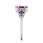 Harlequin gemstone ring featuring a ruby centre and blue sapphire and diamond accents - side