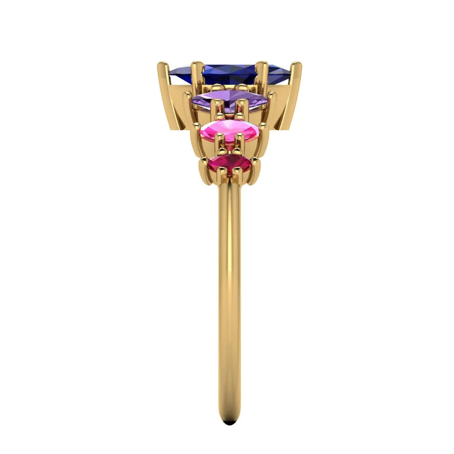 Yellow gold Harlequin ring set with a graduating arc of colourful sapphires and rubies