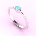 Angled view of the Mini Astraea white metal ring showcasing the marquise aquamarine and textured milgrain edges.