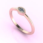 Angled view of an 18ct rose gold ring with a horizontal marquise diamond and fine milgrain textured edges.