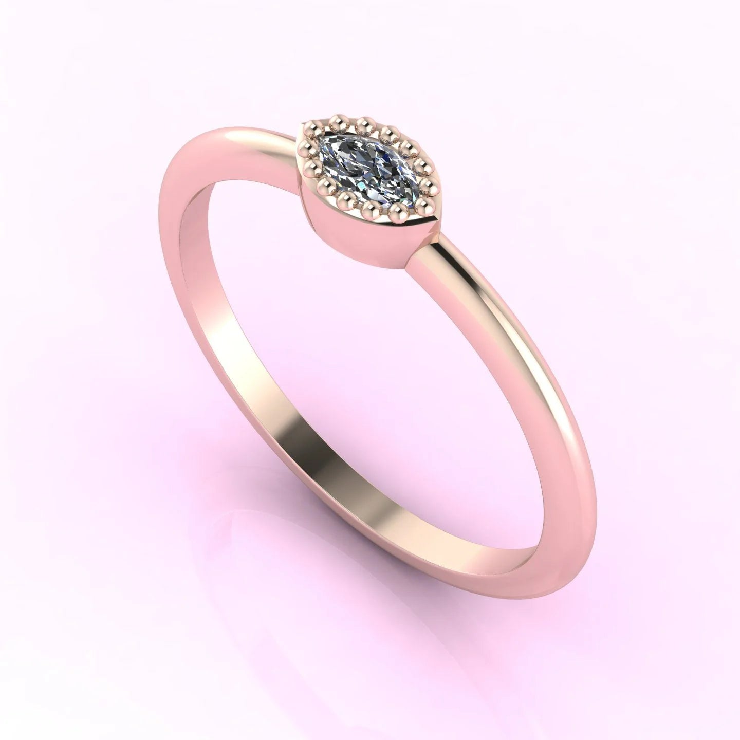 Angled view of an 18ct rose gold ring with a horizontal marquise diamond and fine milgrain textured edges.