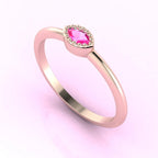 Angled view of an 18ct rose gold ring with a horizontal marquise pink sapphire and delicate milgrain edges.