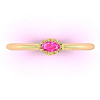 Bird’s eye view of the 18ct yellow gold Mini Astraea ring showing the marquise-cut pink sapphire set horizontally across the finger.