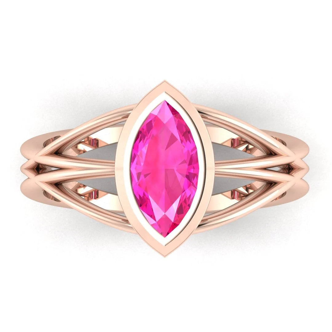 Infinity marquise pink sapphire ring in 18ct rose gold, overhead view showing the vivid pink sapphire set in the continuous wrap band, handmade in London