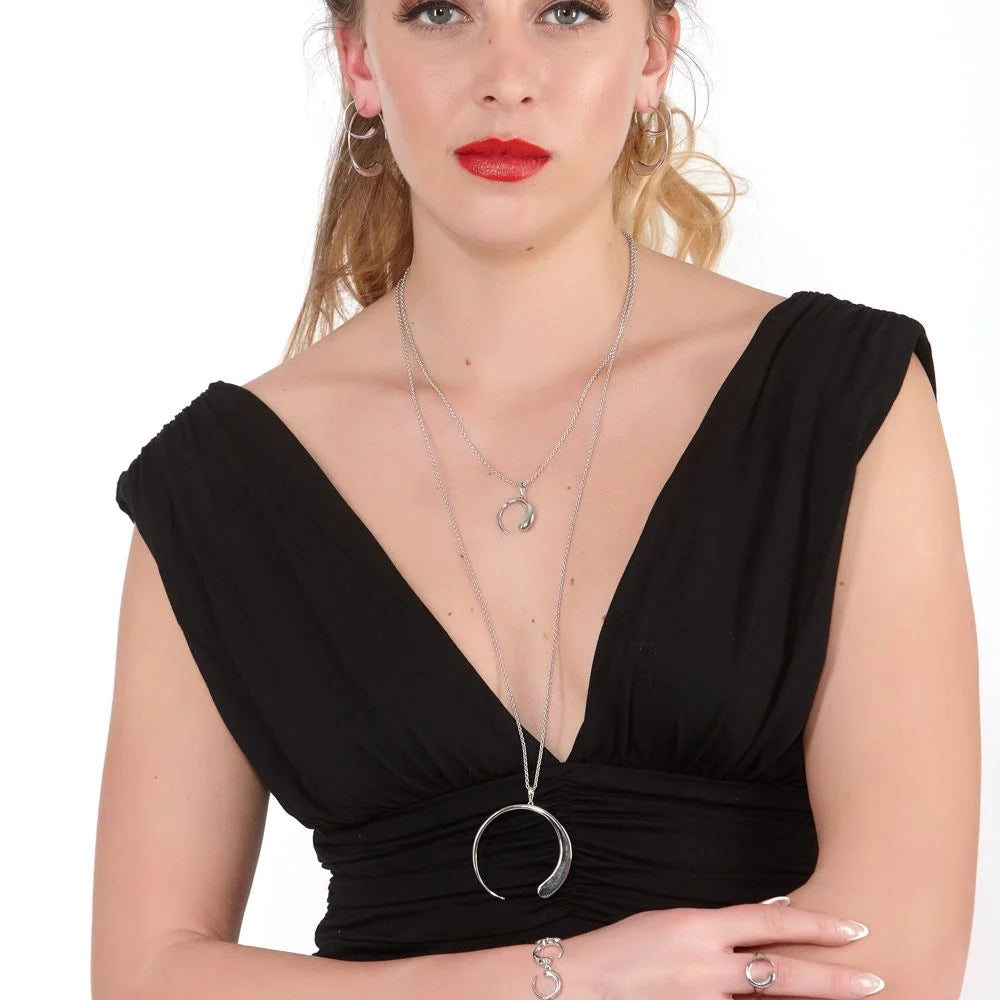 Large Luna Statement Pendant in sterling silver — model side profile showing the fine chain and open crescent pendant
