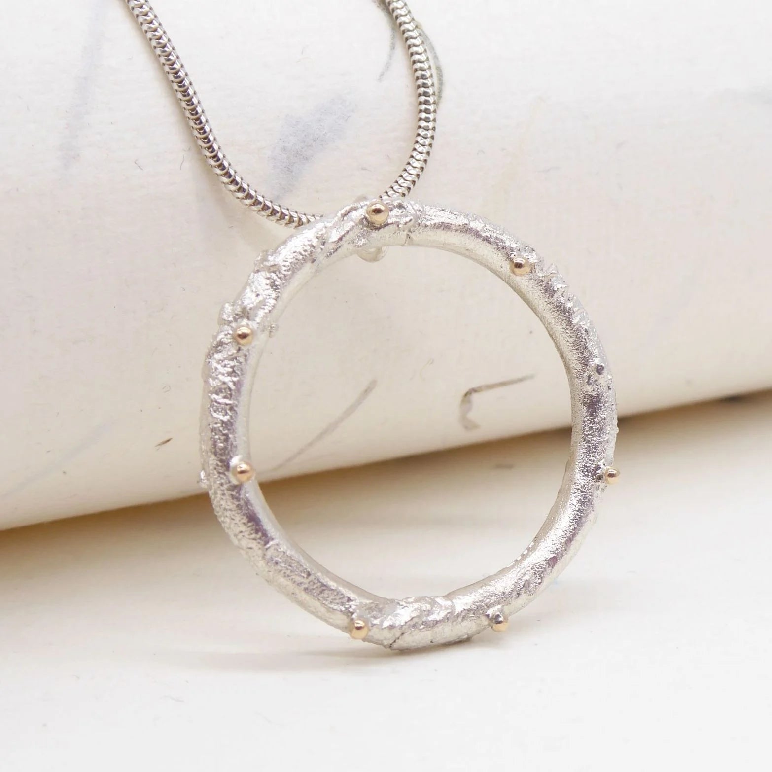 Rivda large organic loop pendant in sterling silver with 9ct yellow gold bead detail