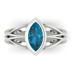 Infinity marquise London blue topaz ring in white gold or platinum, overhead view showing the deep inky blue of the marquise cut stone, handmade in London