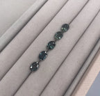 oval teal sapphires, loose on velvet tray for client selection for a bespoke engagement ring