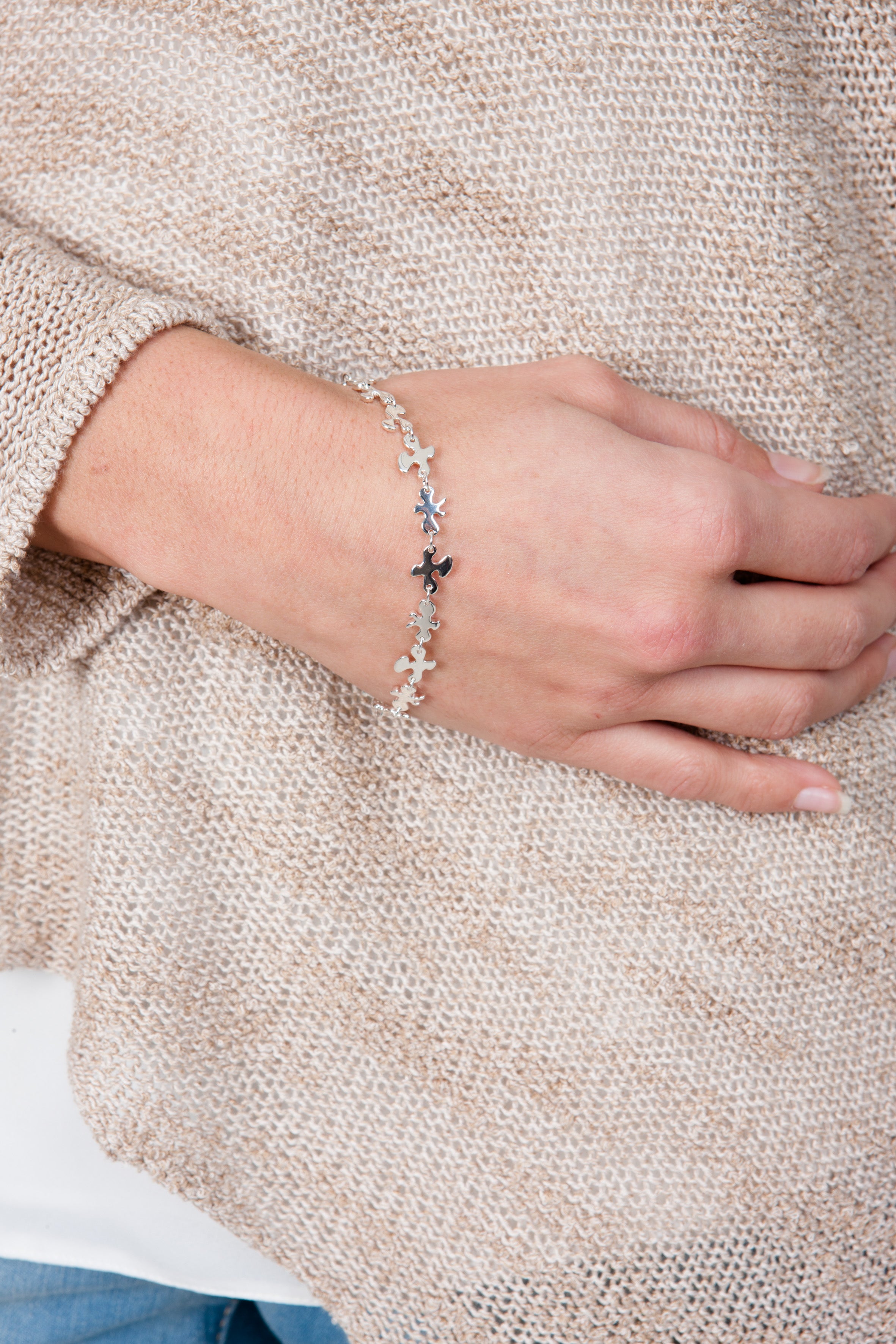 Close-up shot of the  fine silver Splat bracelet worn on a wrist, demonstrating the delicate fit and drape.