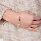 Close-up shot of the fine silver Splat bracelet worn on a wrist, demonstrating the delicate fit and drape.