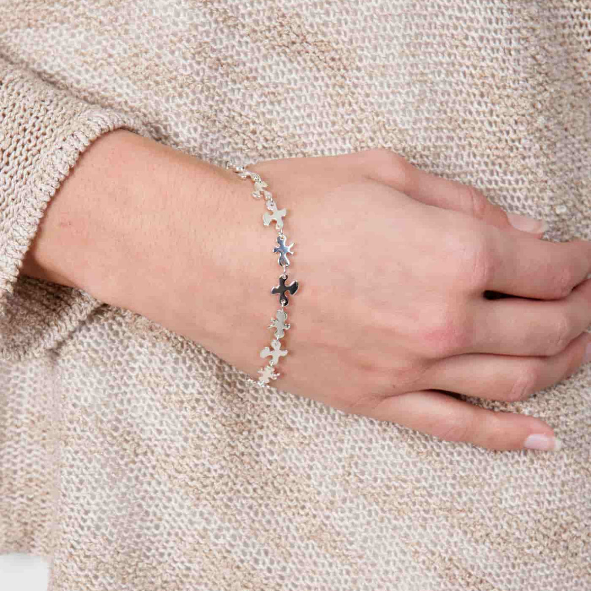 Close-up shot of the fine silver Splat bracelet worn on a wrist, demonstrating the delicate fit and drape.