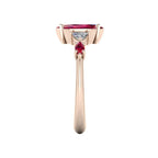 Maisie marquise ruby and diamond ring in 18ct rose gold, angled view showing trillion diamond and marquise ruby shoulders