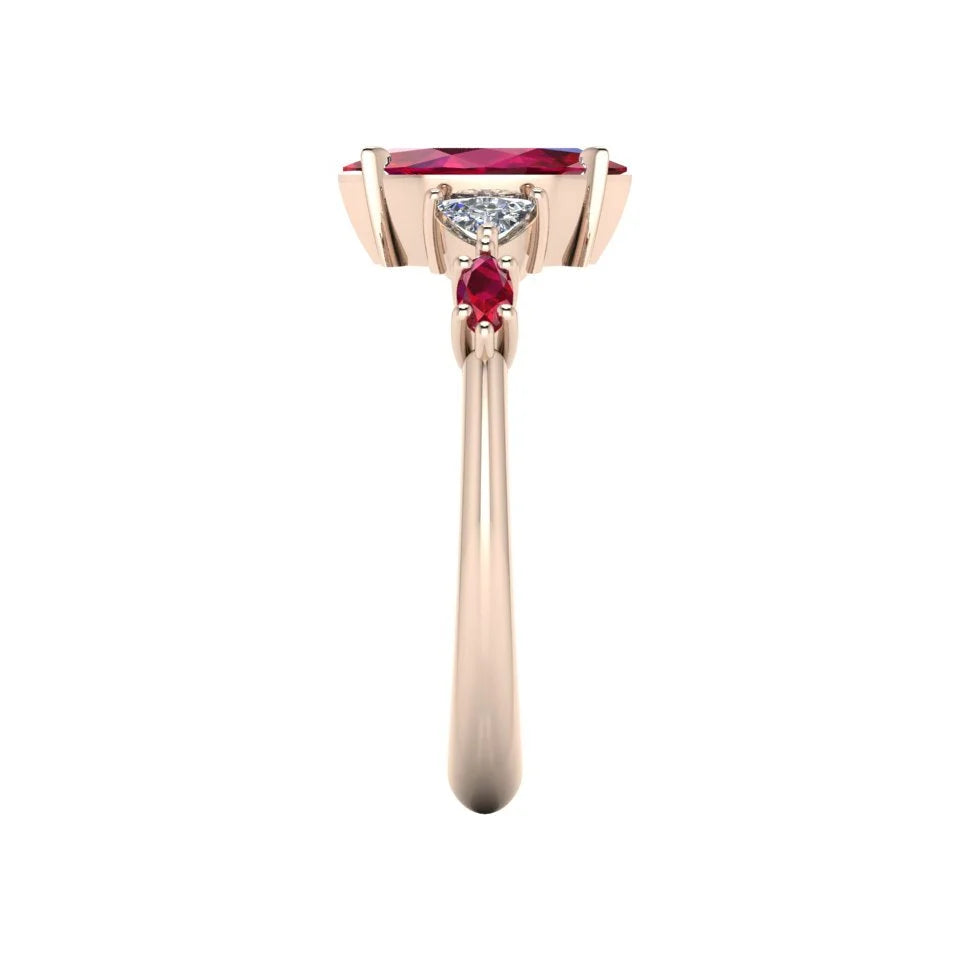 Maisie marquise ruby and diamond ring in 18ct rose gold, angled view showing trillion diamond and marquise ruby shoulders