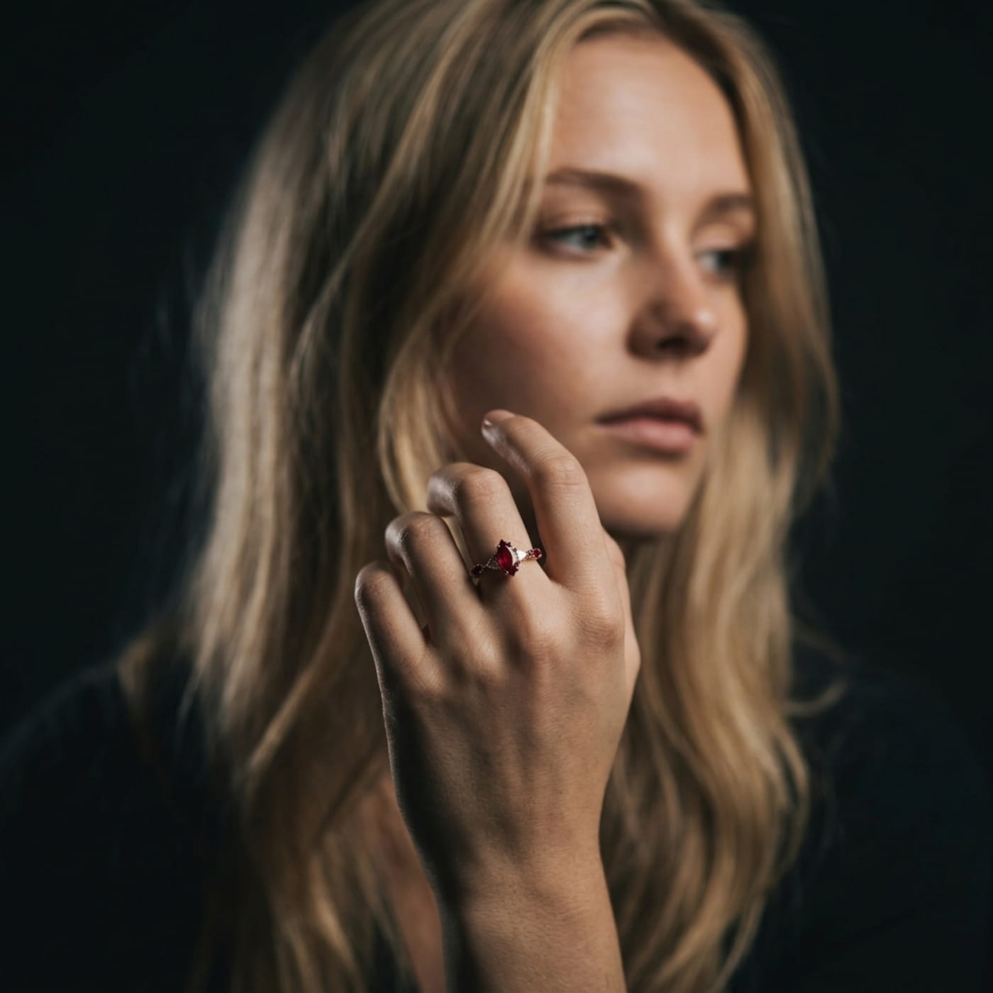 Marquise ruby and diamond ring in rose gold, unique engagement ring design worn on model.