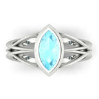 Infinity marquise aquamarine ring in white gold or platinum, overhead view showing the luminous marquise aquamarine set in the continuous wrap band, alternative engagement ring handmade in London