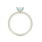 A through-finger view of the Amoret aquamarine ring showing the internal band and the clean, architectural setting symmetry.