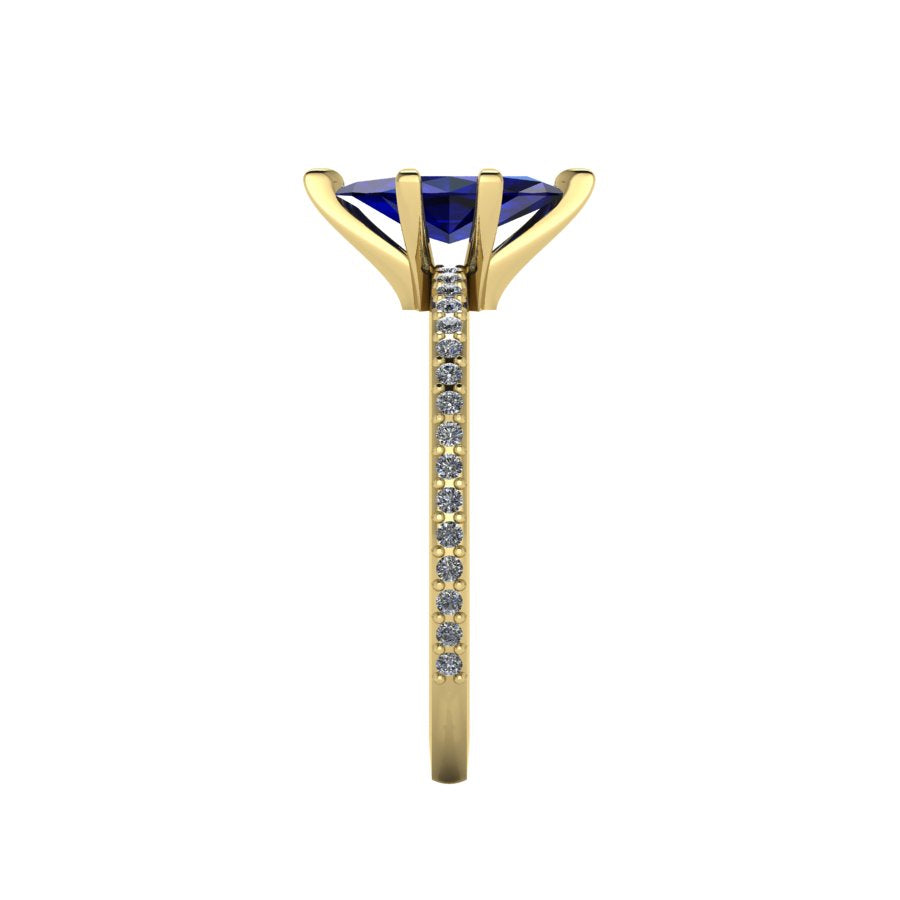 Close-up side view of the 18ct yellow gold Amoret ring highlighting the secure claw setting for the blue sapphire and the grain-set shoulder diamonds.