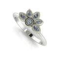 Angled view of an all-diamond cluster statement ring in white gold featuring delicate milgrain details and marquise stones.