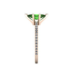 Close-up side view of the 18ct rose gold Amoret ring highlighting the secure claw setting for the green tourmaline and white diamond shoulders.