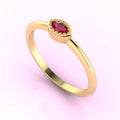 Angled profile of a delicate yellow gold ring with a marquise-cut ruby, showing the intricate metalwork and stone setting.