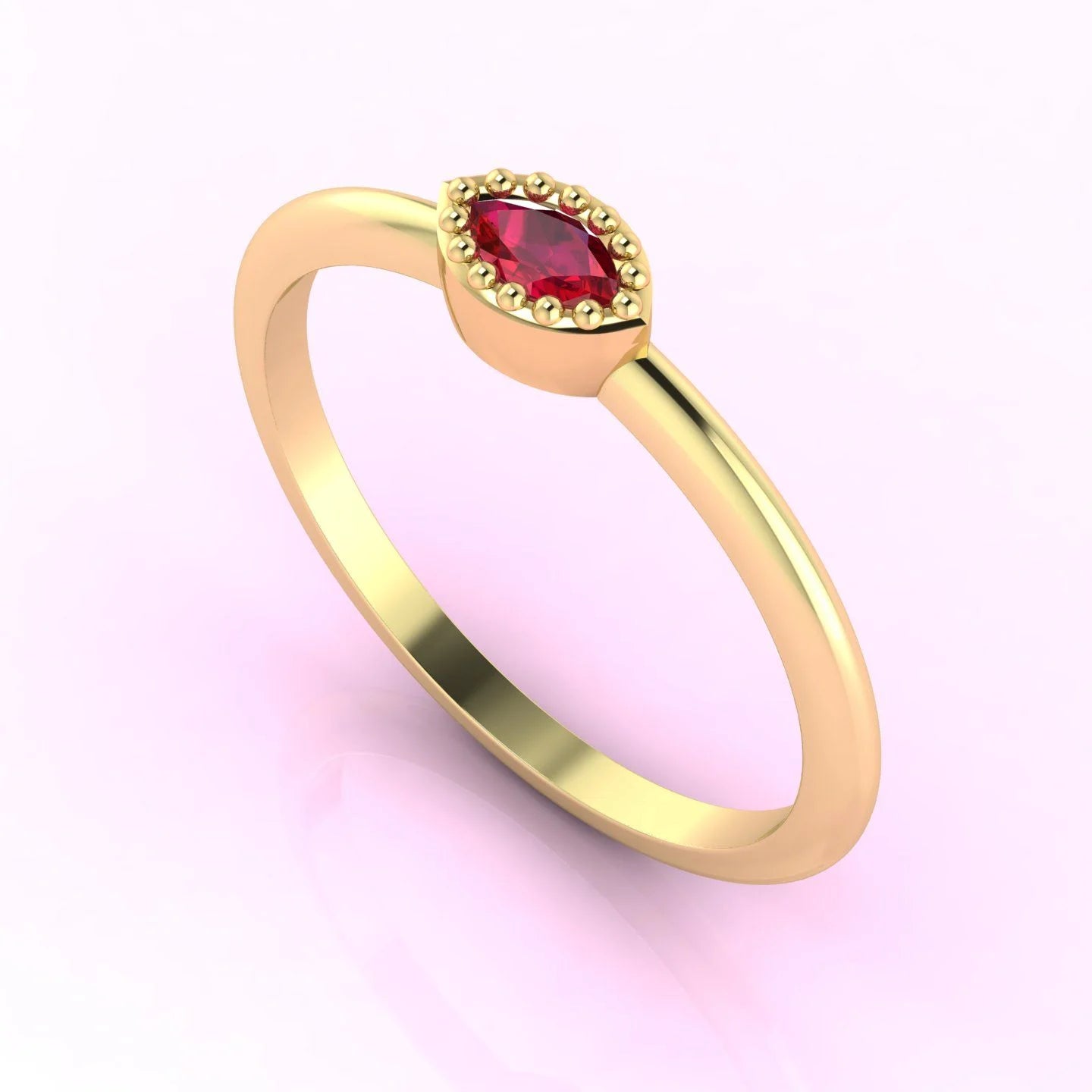 Angled profile of a delicate yellow gold ring with a marquise-cut ruby, showing the intricate metalwork and stone setting.