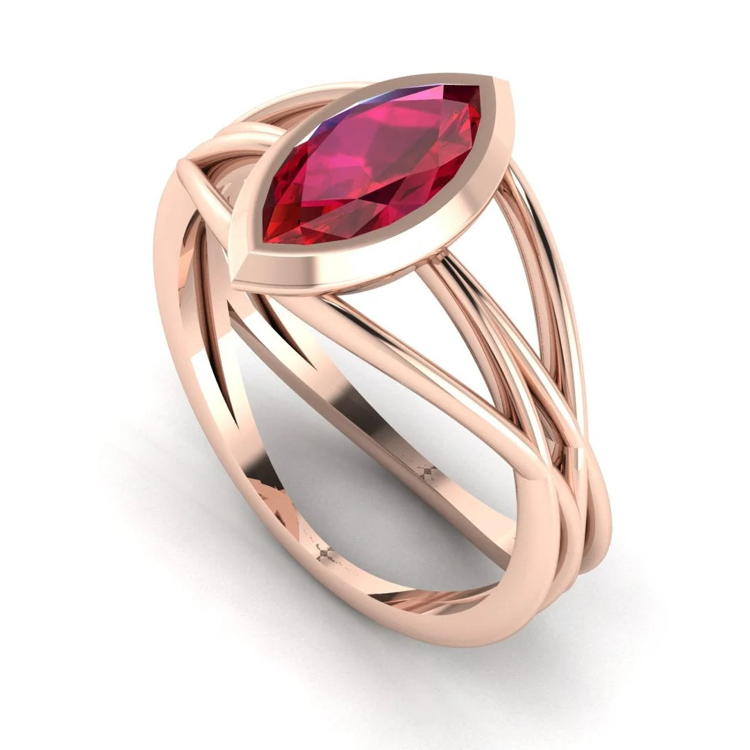 Infinity marquise ruby ring in 18ct rose gold, profile view showing the deep red ruby set in the sculptural wrap-around band, alternative engagement ring handmade in our London studio