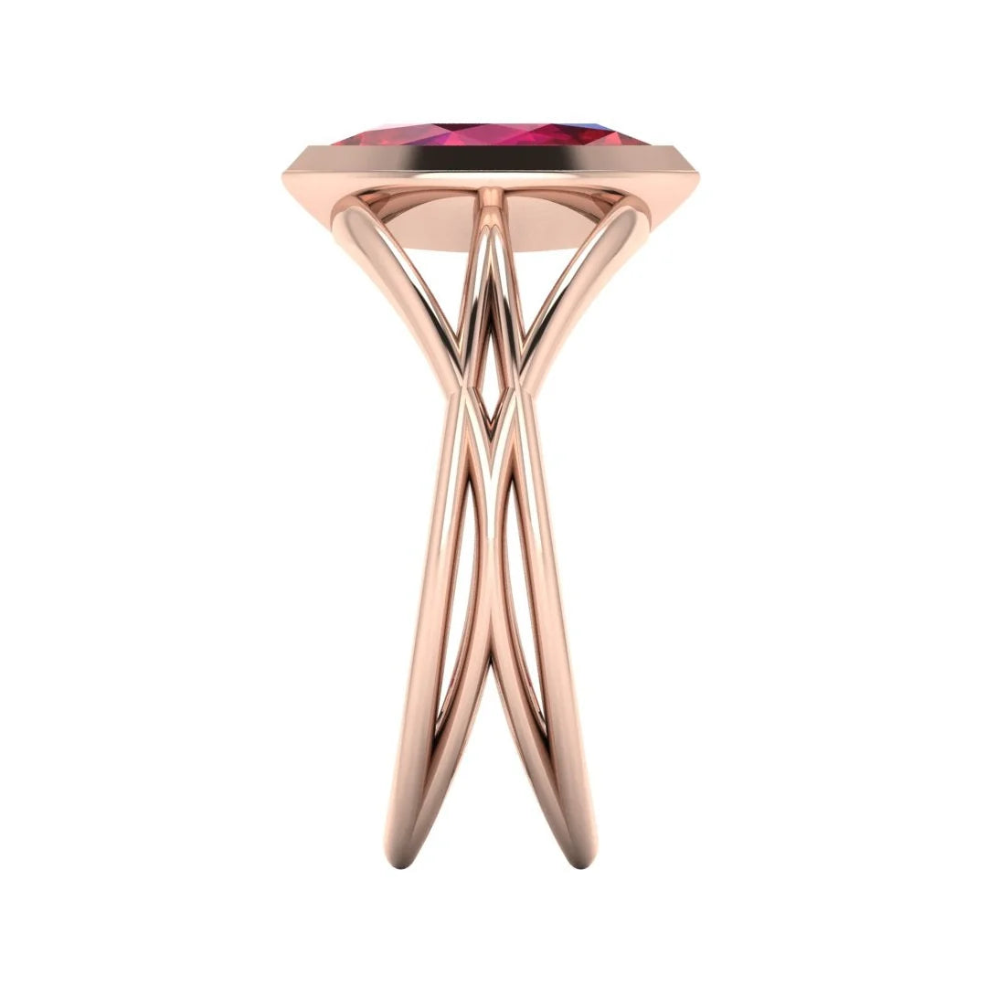Infinity marquise ruby ring in 18ct rose gold, side profile showing the elegant low-set marquise ruby and sculptural band, handmade in our London studio