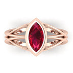 Infinity marquise ruby ring in 18ct rose gold, overhead view showing the vivid marquise ruby in the continuous wrap band, handmade in London