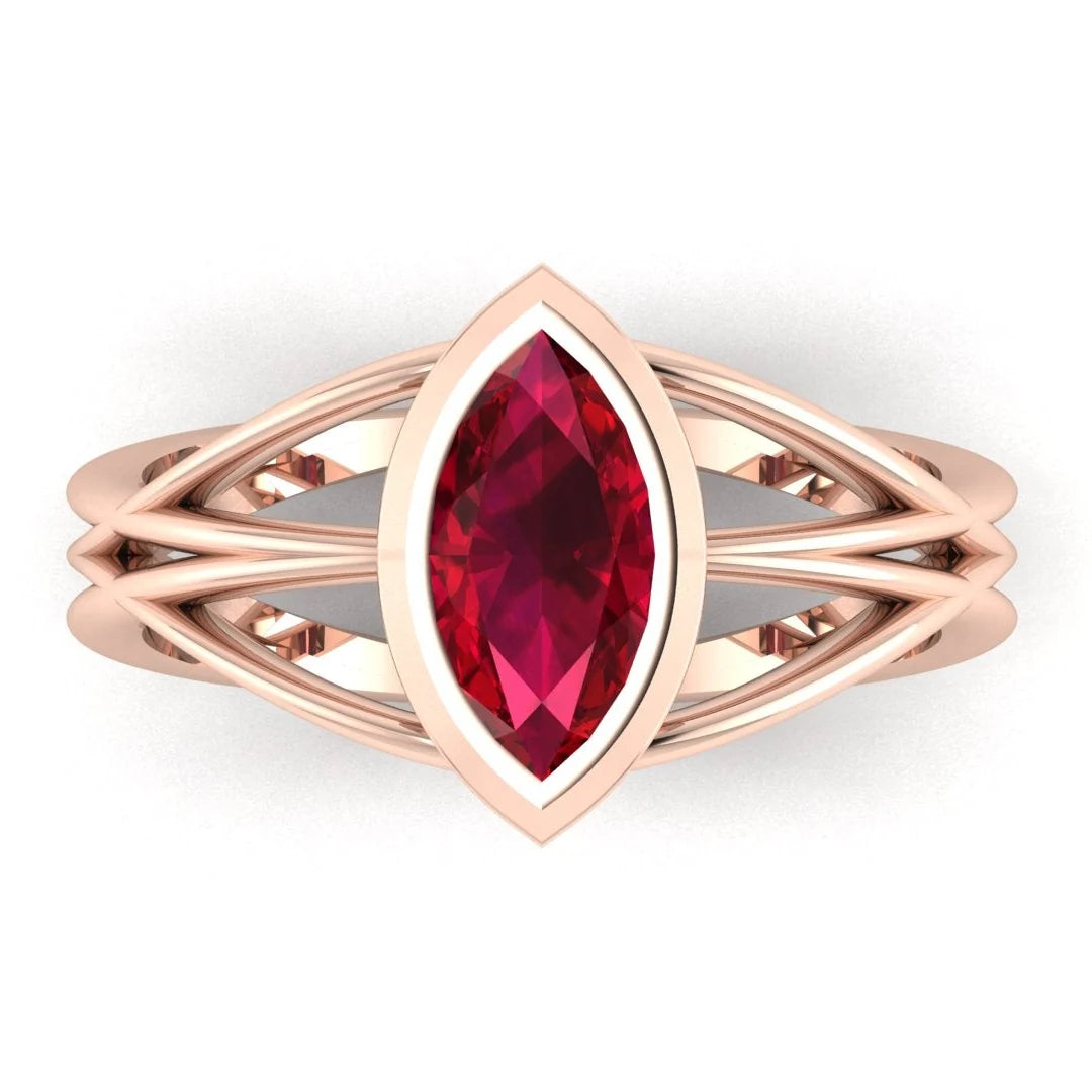 Infinity marquise ruby ring in 18ct rose gold, overhead view showing the vivid marquise ruby in the continuous wrap band, handmade in London
