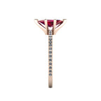Close-up side view of the 18ct rose gold Amoret ring highlighting the secure claw setting for the ruby and the grain-set shoulder diamonds.