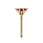 Close-up side view of the 18ct yellow gold Amoret ring highlighting the secure claw setting for the ruby and diamond-set shoulders.