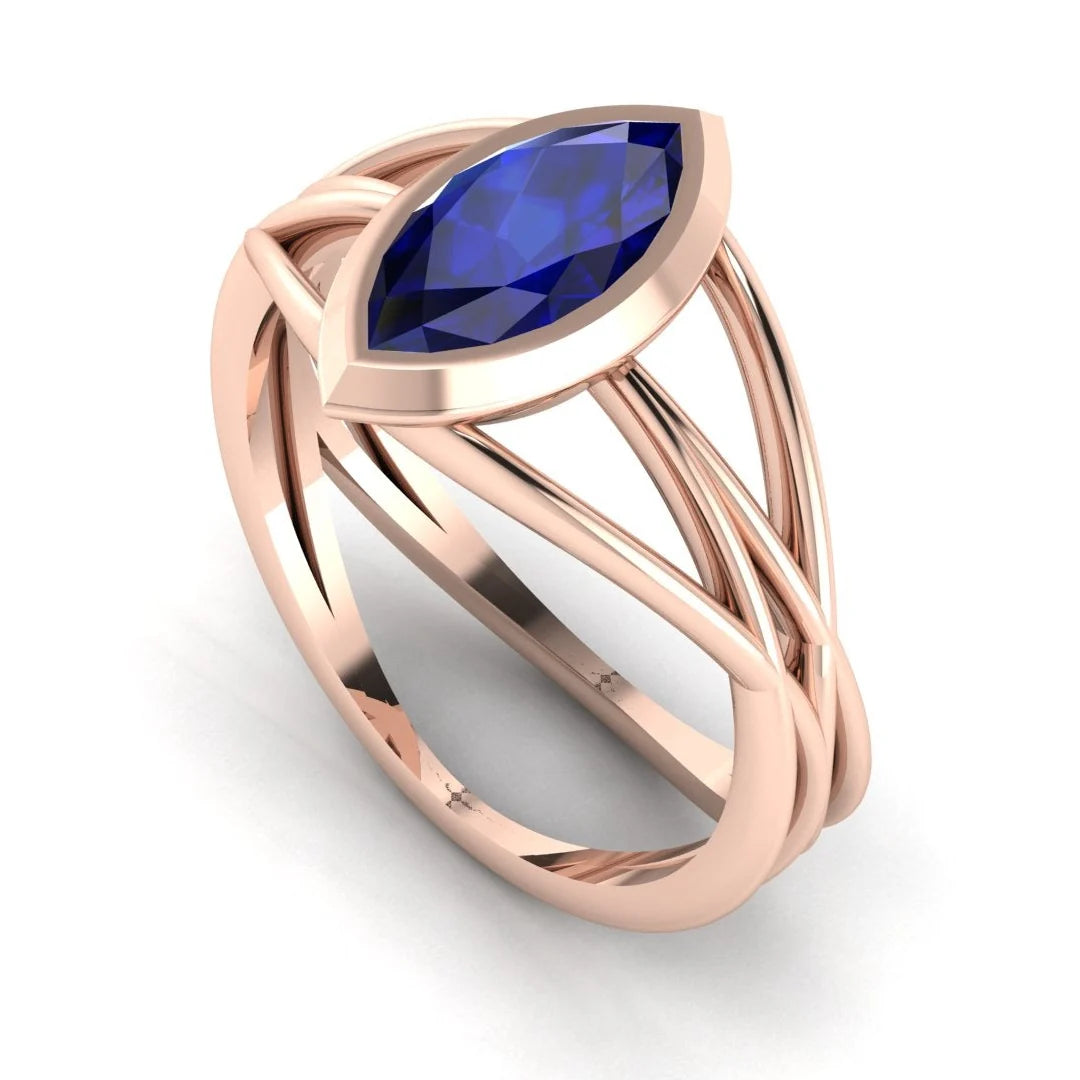 Infinity marquise blue sapphire ring in 18ct rose gold, profile view showing the sculptural wrap-around band, handmade in our London studio