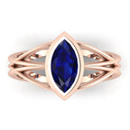 Infinity marquise blue sapphire ring in 18ct rose gold, overhead view showing the deep blue sapphire set in the continuous wrap band, alternative engagement ring handmade in London