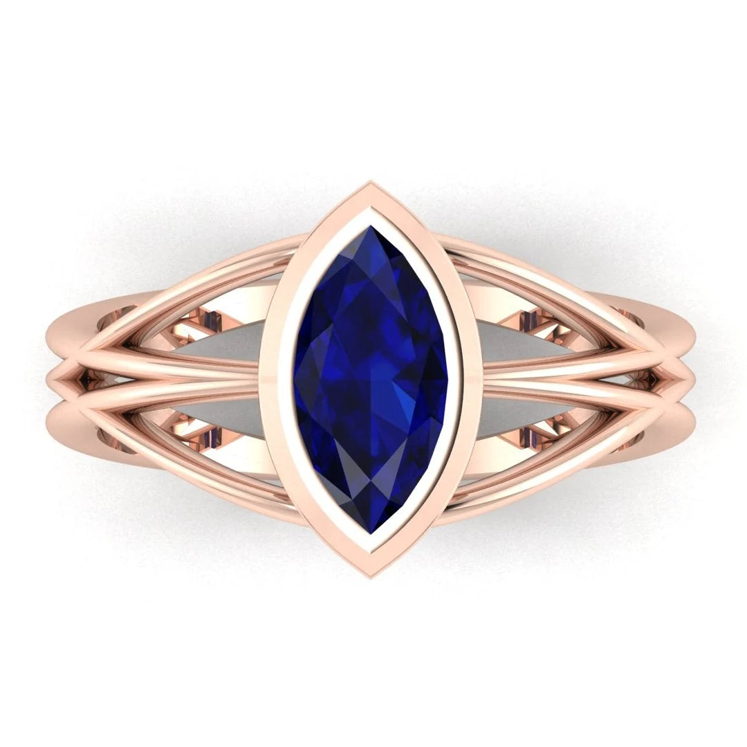 Infinity marquise blue sapphire ring in 18ct rose gold, overhead view showing the deep blue sapphire set in the continuous wrap band, alternative engagement ring handmade in London