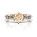 Rose gold ring with a large champagne diamond and small white marquise diamonds on a white background