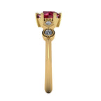 Side view of the Milena five-stone ring — round brilliant ruby flanked by brilliant-cut and marquise diamonds in yellow gold