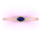 Top view of Mini Astraea 18ct rose gold ring featuring a horizontally set marquise-cut blue sapphire.