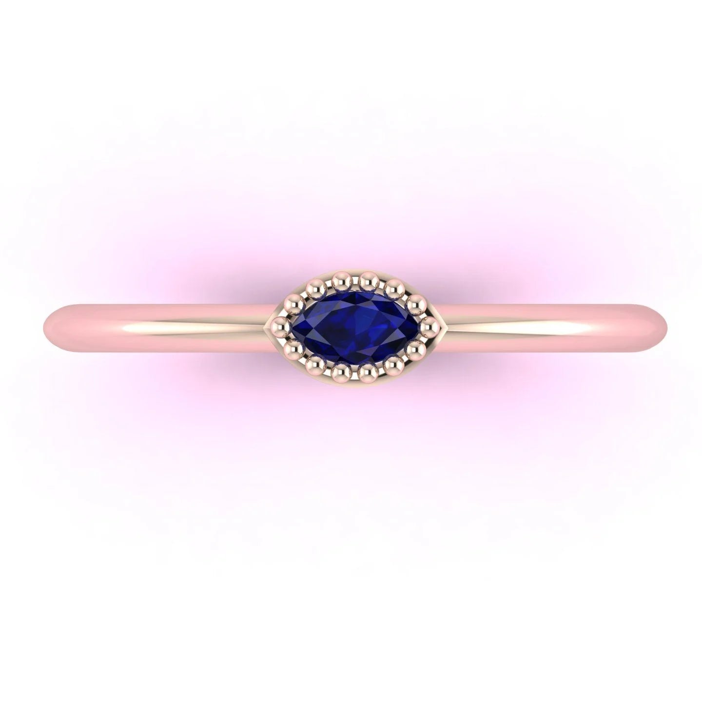 Top view of Mini Astraea 18ct rose gold ring featuring a horizontally set marquise-cut blue sapphire.