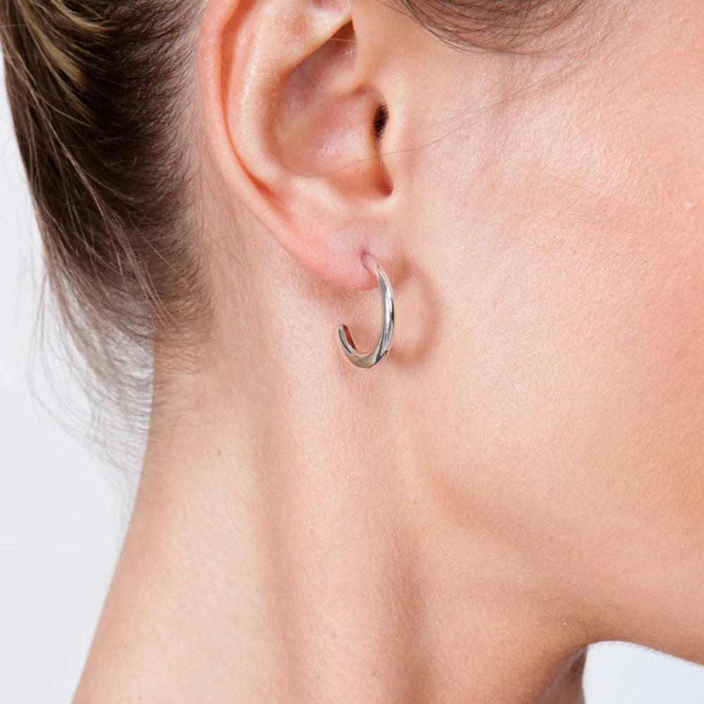 Mini Drop Hoop Earrings in sterling silver — model close-up showing single hoop worn in ear