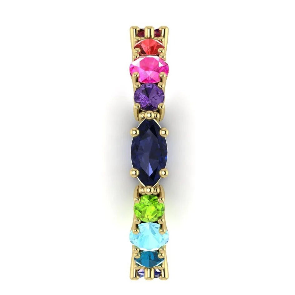 Close-up side view of the 18ct yellow gold Allsorts ring highlighting the blue to green for the multi-coloured gemstones.