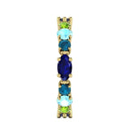 Close-up side view of the 18ct yellow gold Allsorts ring highlighting the blue/green gemstones for the multi-coloured gemstones.