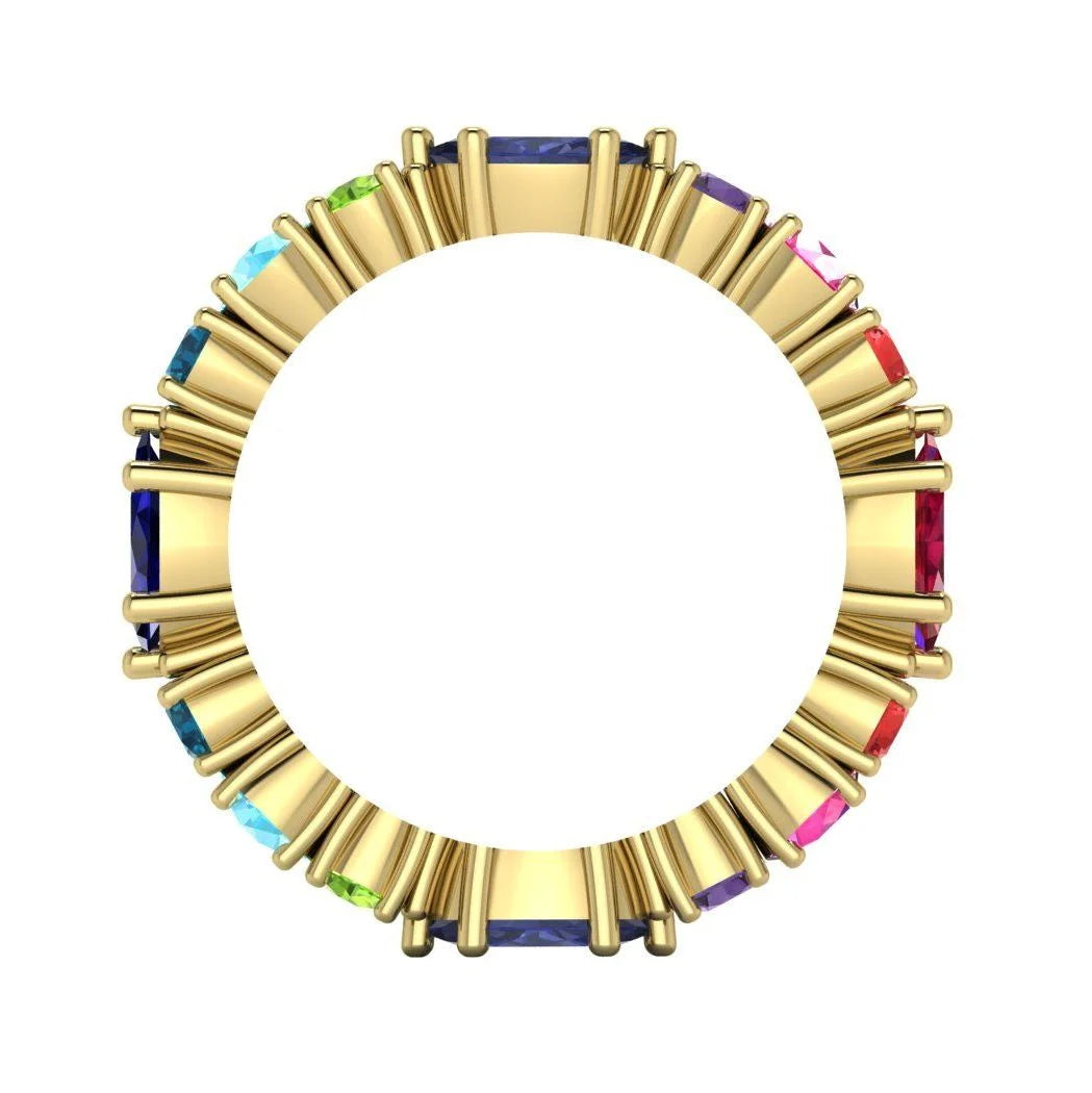 Looking through the band of the yellow gold Allsorts ring. This view demonstrates the solid construction and the open-back settings designed to allow maximum light through the colourful gemstones.
