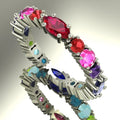 Profile view of the multi-coloured Allsorts eternity ring in 18ct white gold showing the alternating marquise and round stone settings.