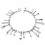 Multi Drip Silver Bracelet on white background — twenty polished sterling silver droplets on rolo chain with T-bar fastening